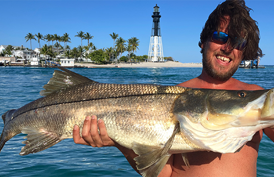 Man holding a large fish on an inshore fishing charter